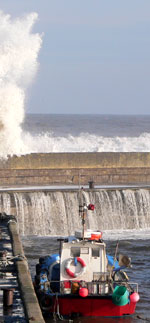 Fishing boat in stormy harbour